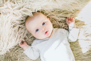 baby in white onesie